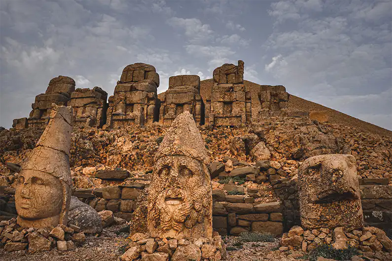 the giant stone man and beast statues on Mount Nemrut in Turkey